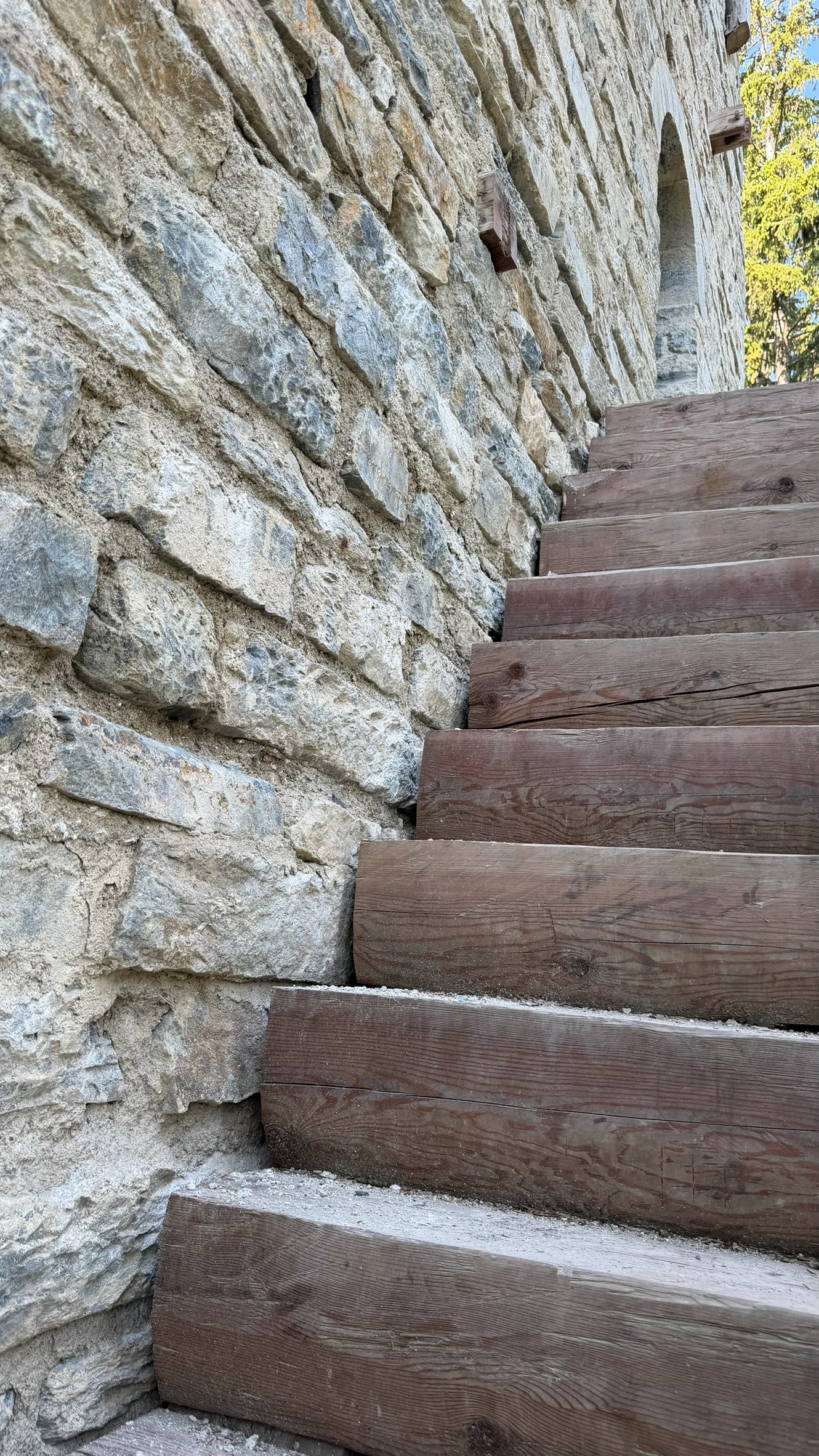 Removable wooden staircase providing access to the raised entrance.
