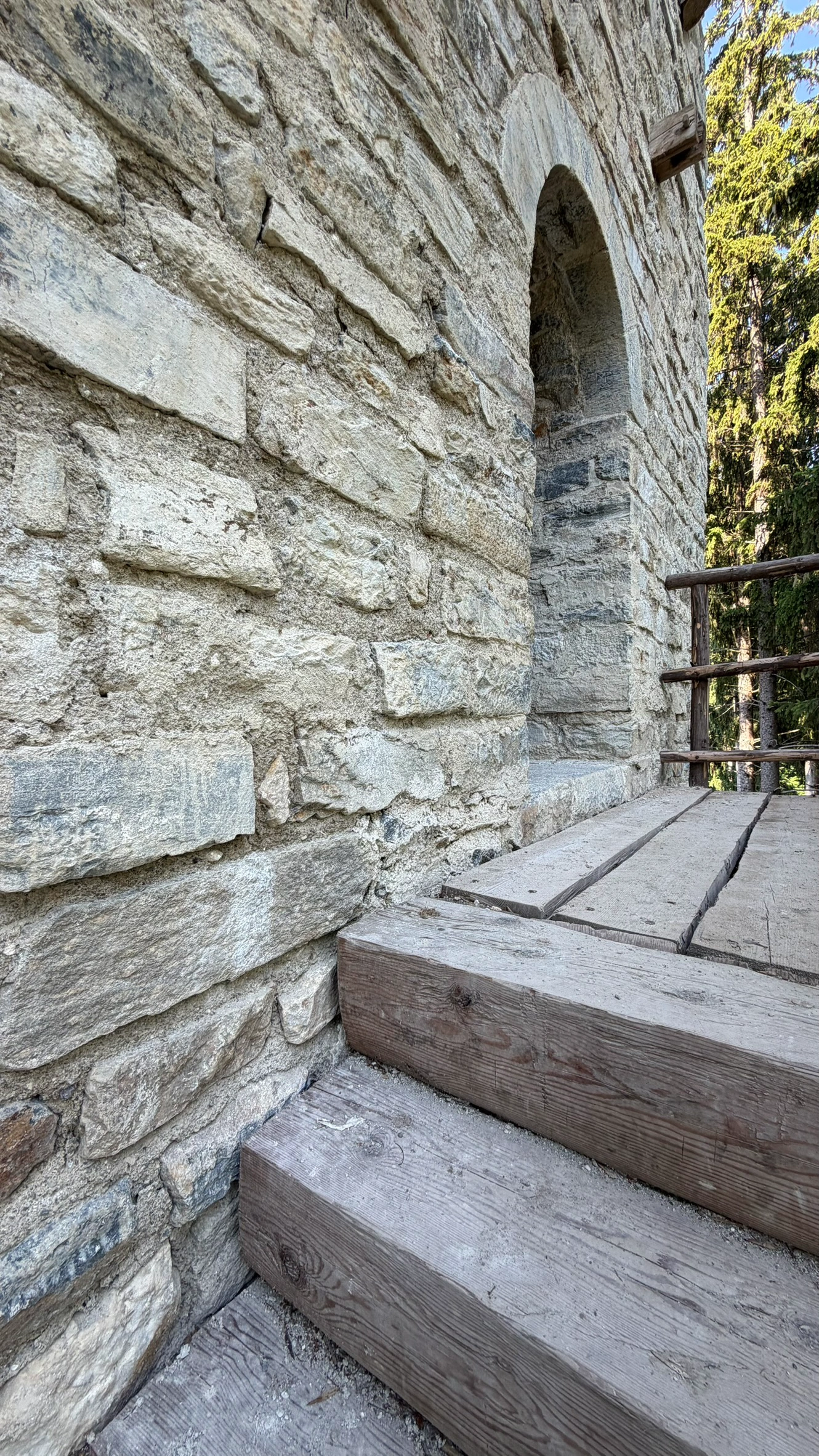 Holztreppe zum Podest vor dem Hocheingang.