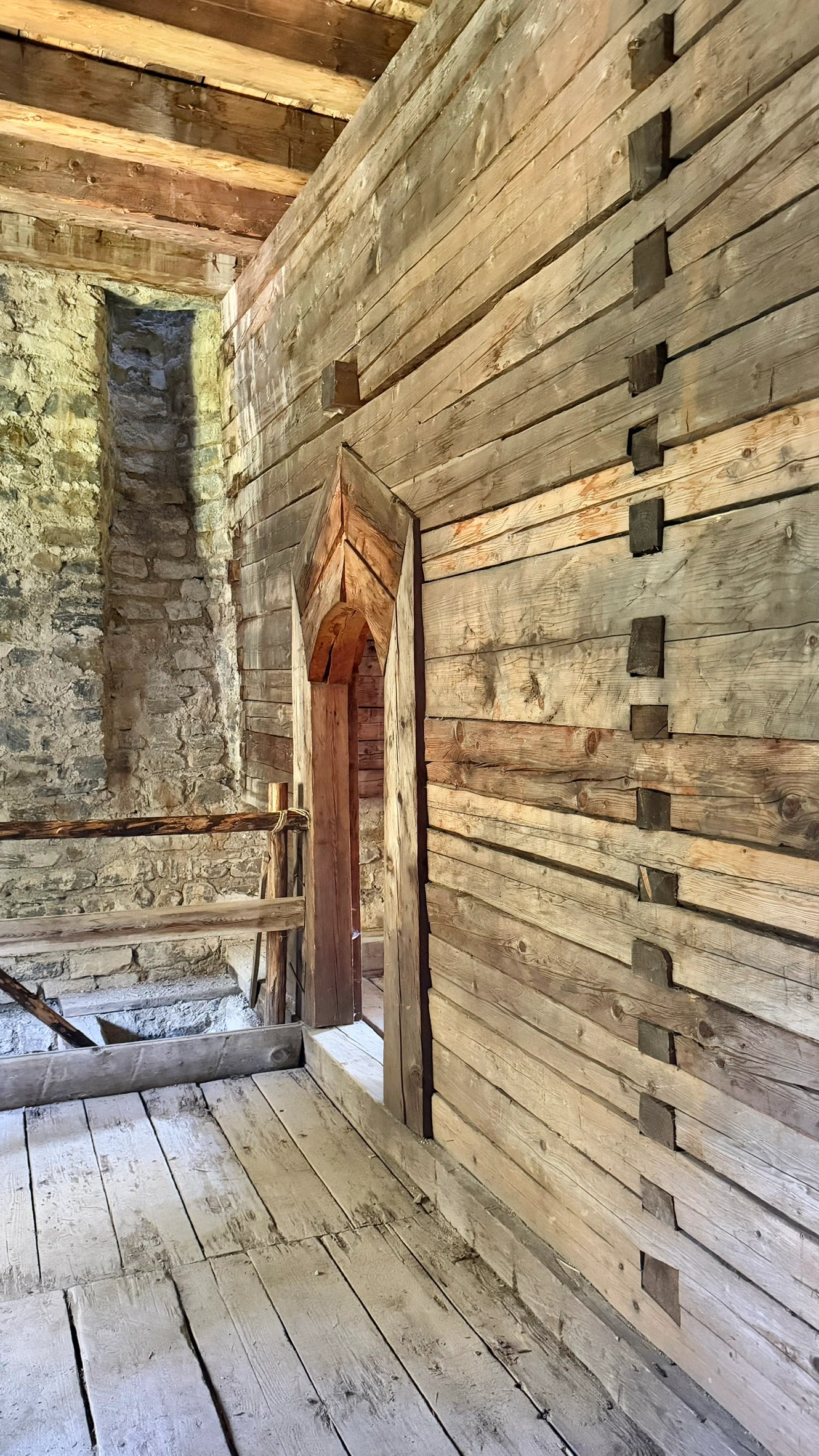 A timber block wall separates the summer room from the winter room and sleeping chamber.