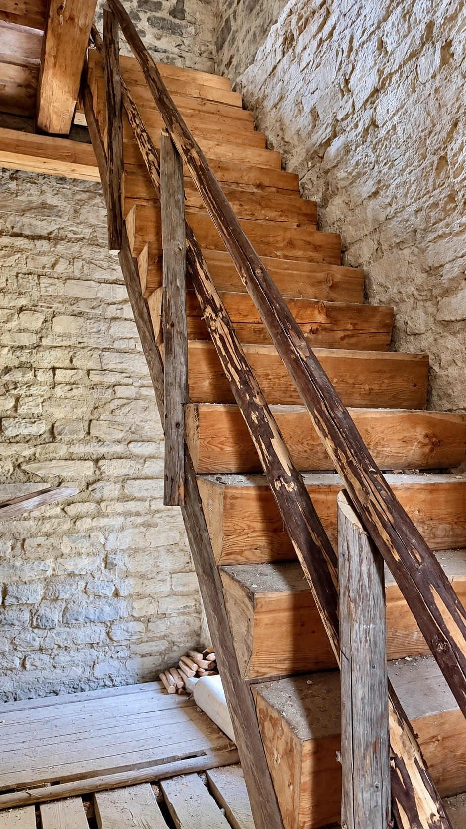 The wooden staircase is built against the north wall of the tower.