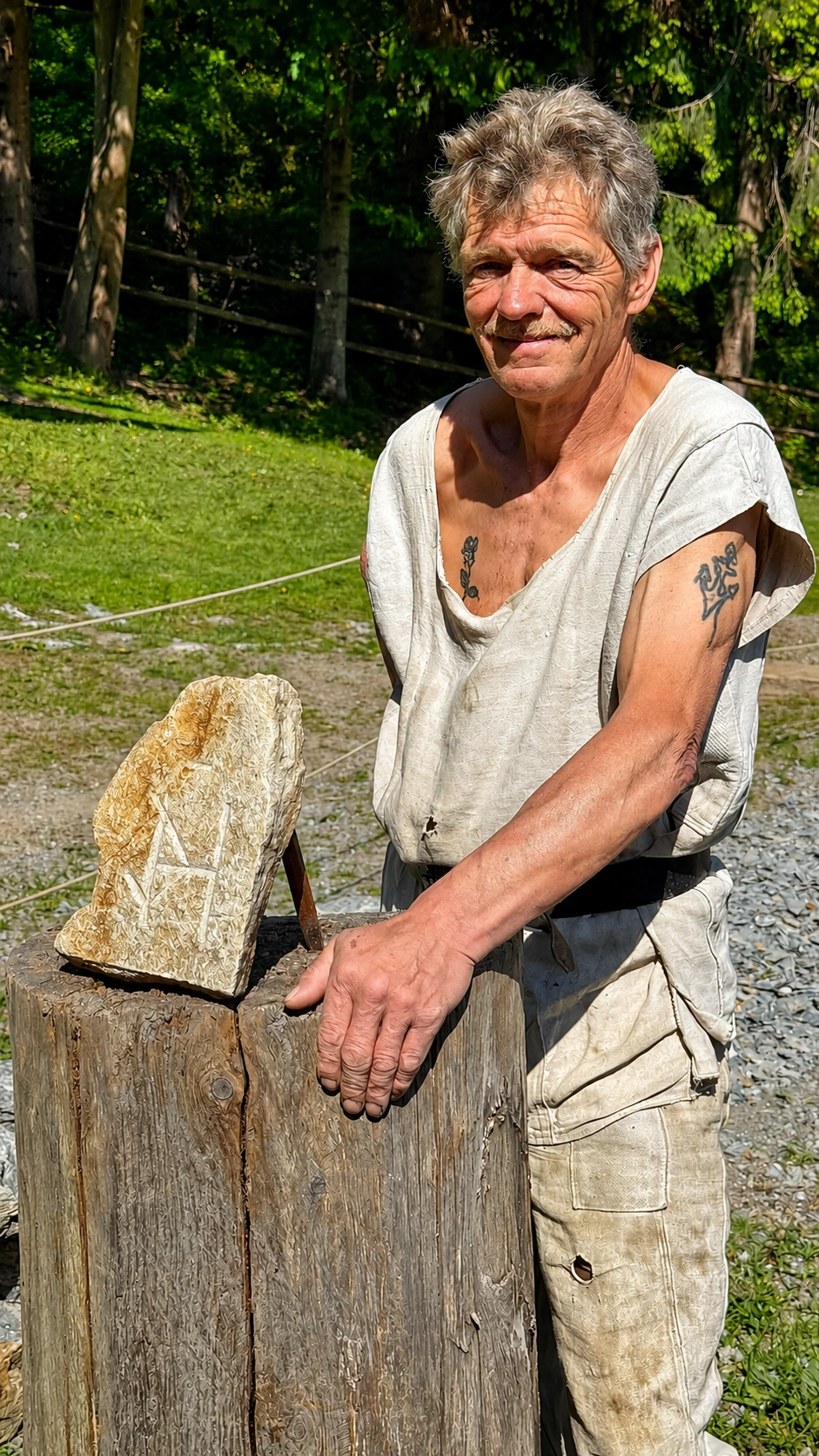Stonemason presenting a roughly worked stone block