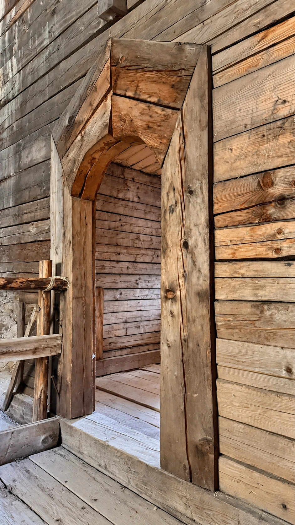 Wooden door surround and doorway leading to the winter room.