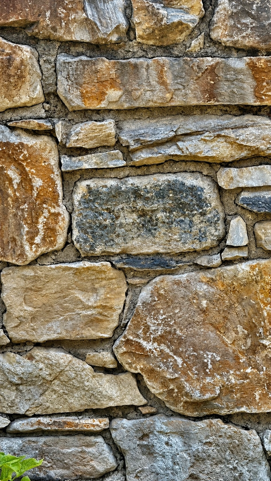 Finished curtain wall built from locally quarried stone laid in irregular courses