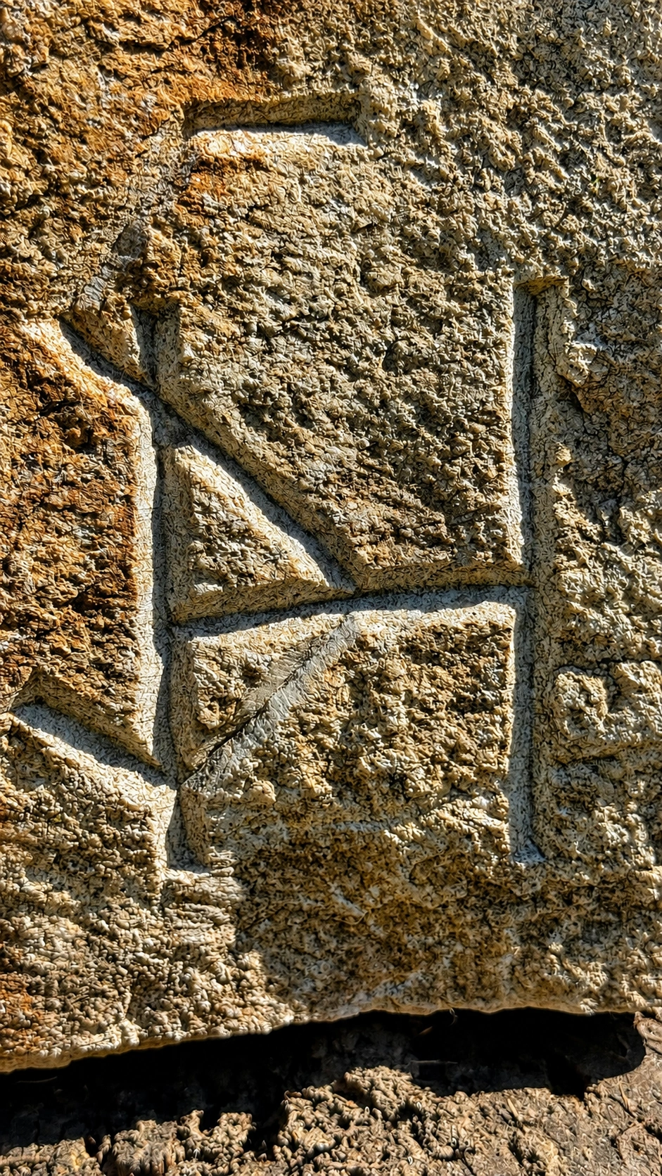 Close-up of carved grooves on the stone surface