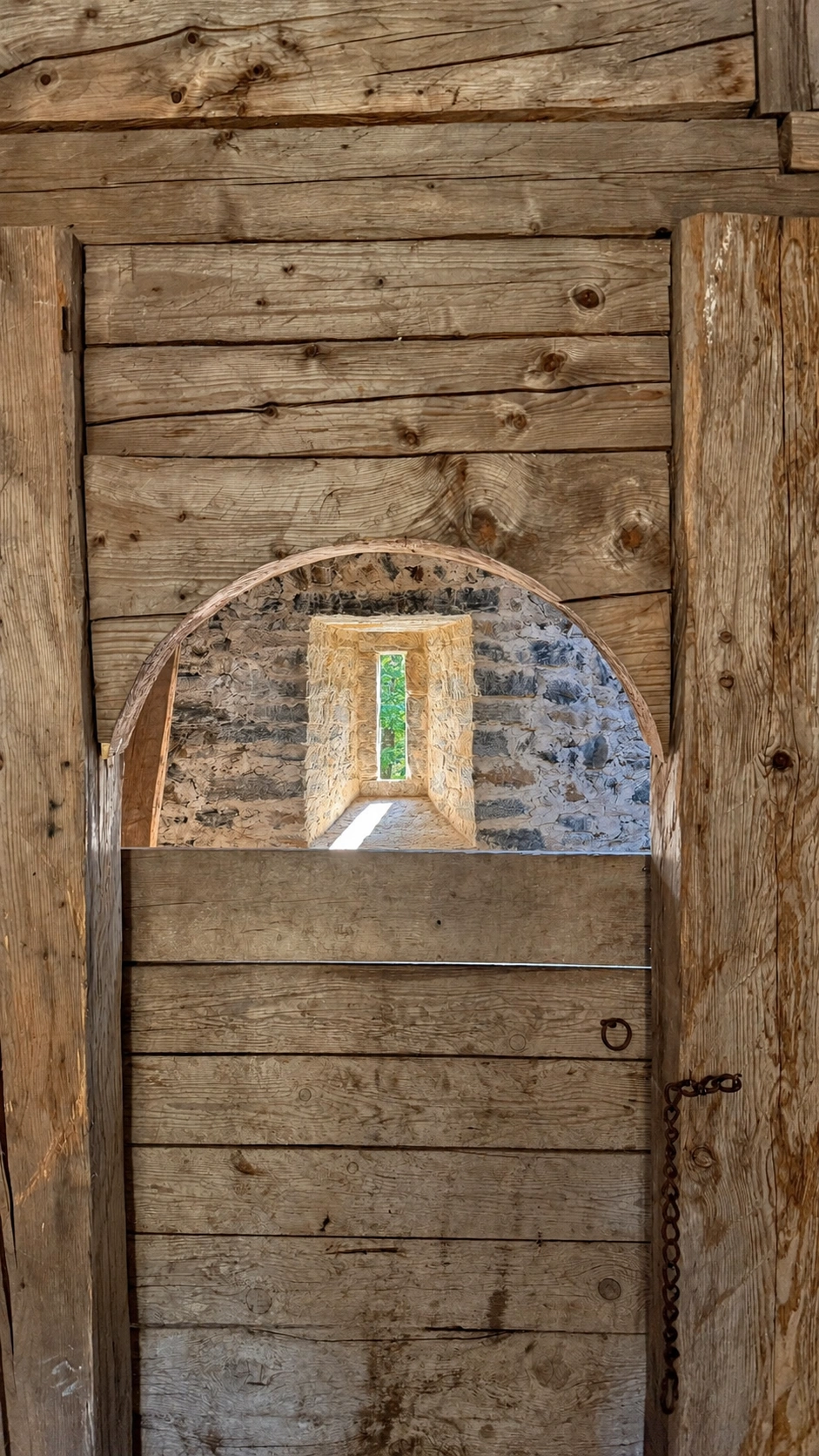 Wooden door leading from the summer room to the sleeping chamber.