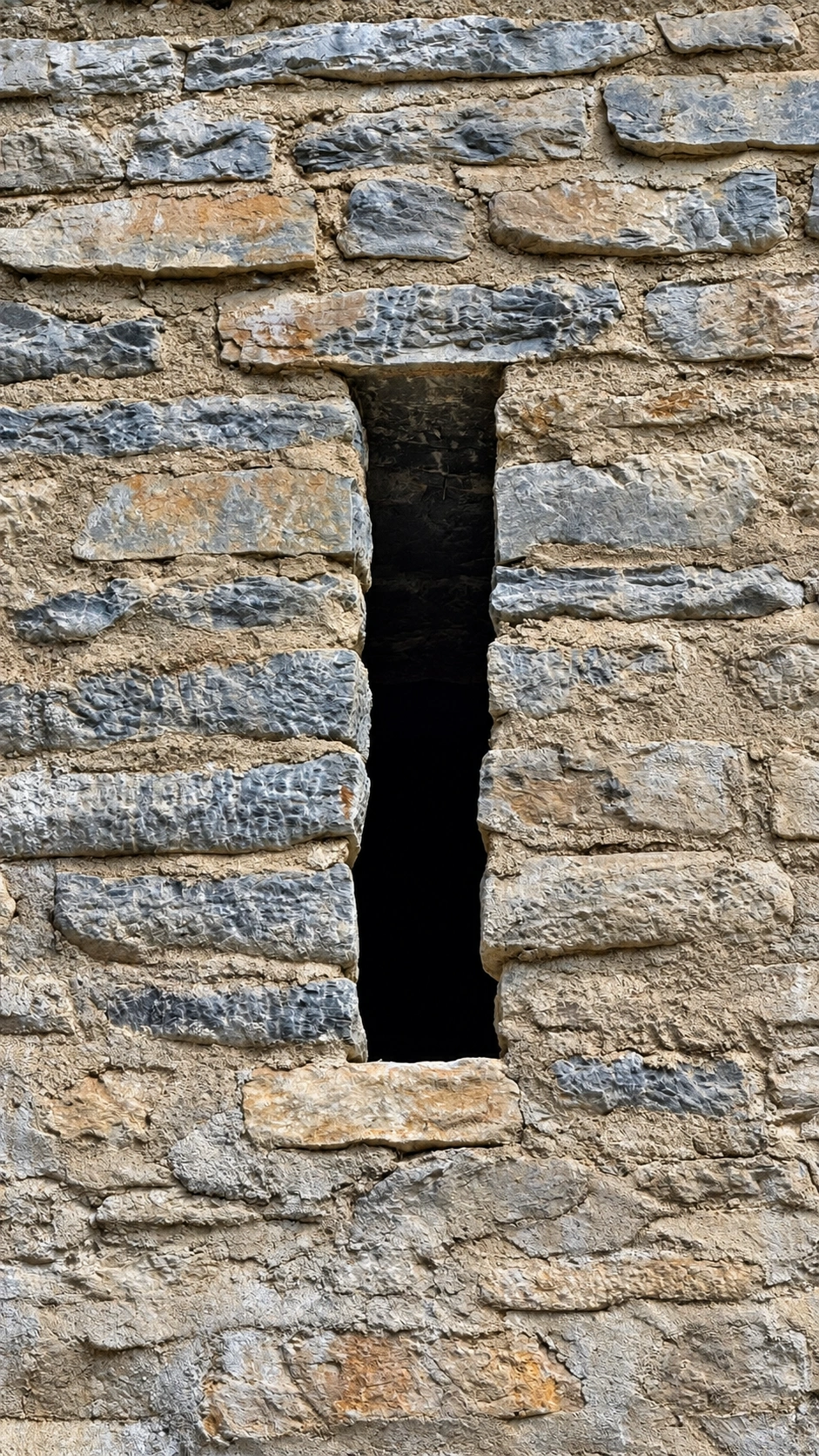 A narrow-slit window illuminates the tower interior while limiting access from outside.