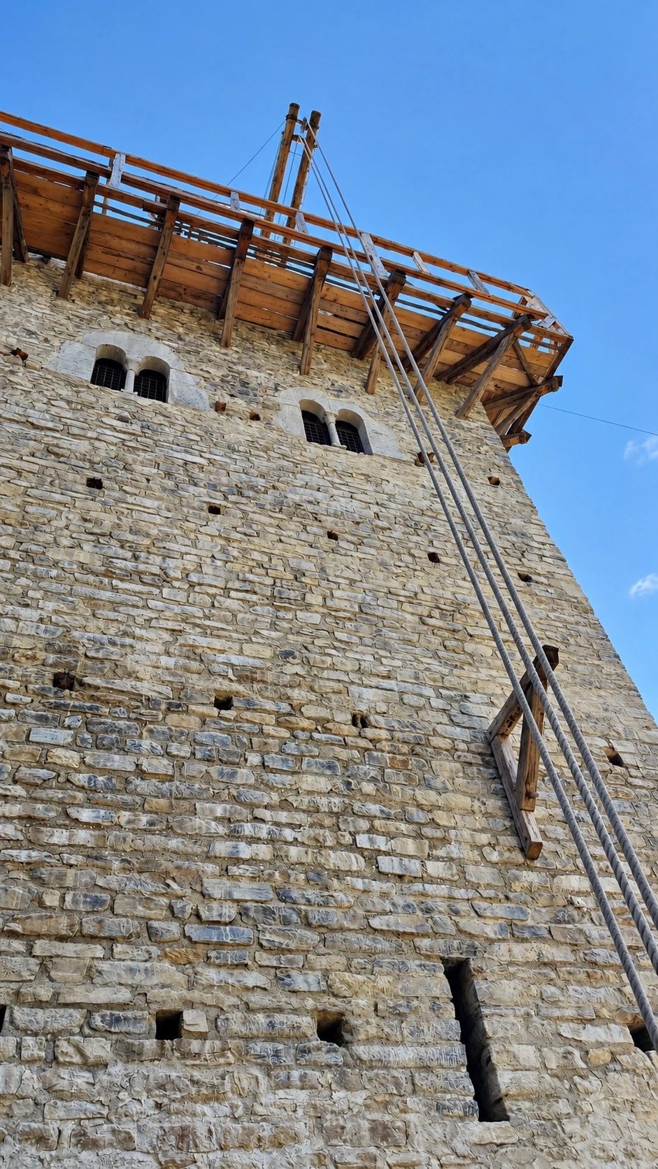 Biforate windows in the tower's west wall, viewed from outside.