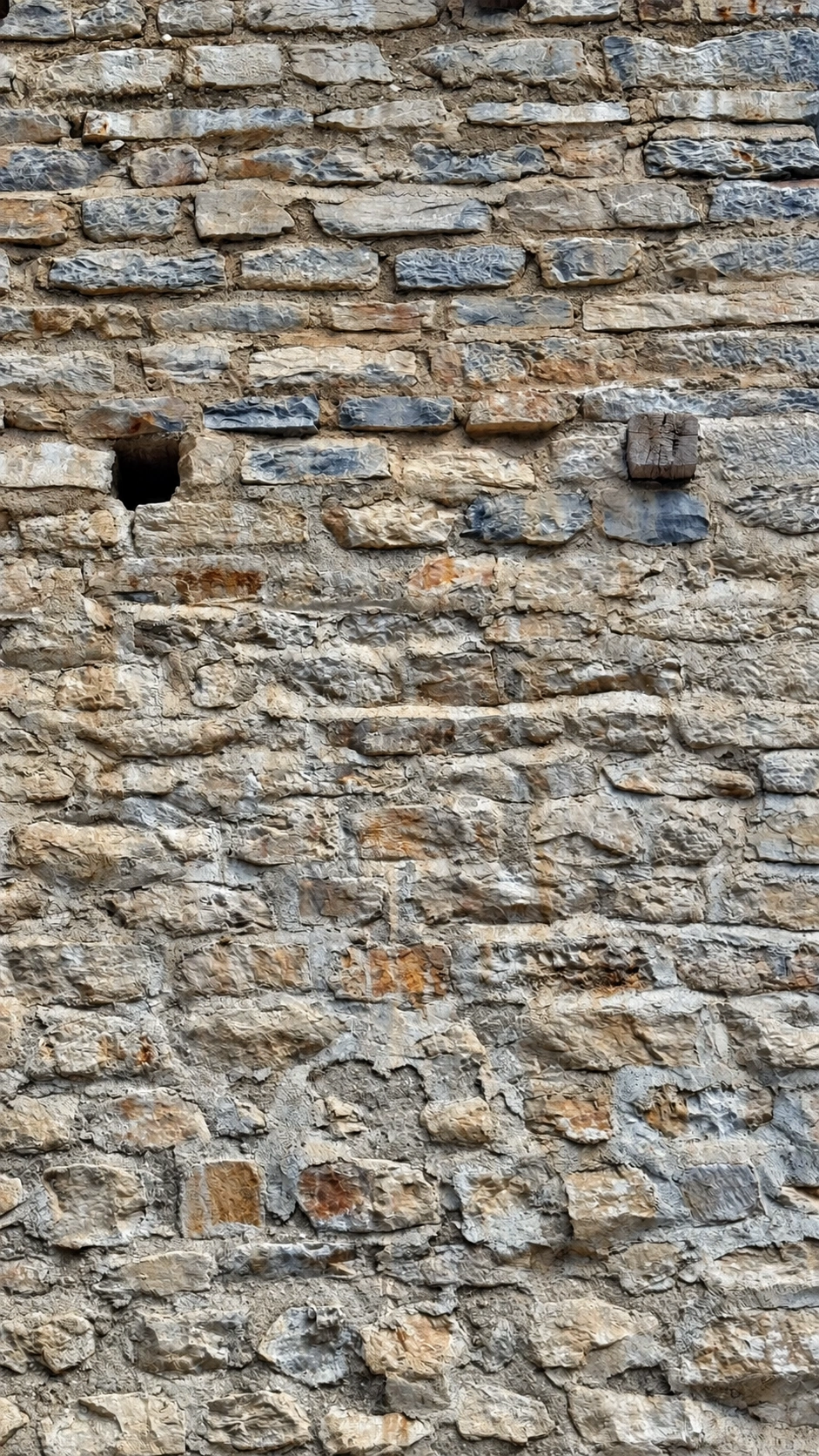 Square openings in the masonry and projecting beams mark former wooden scaffolding.