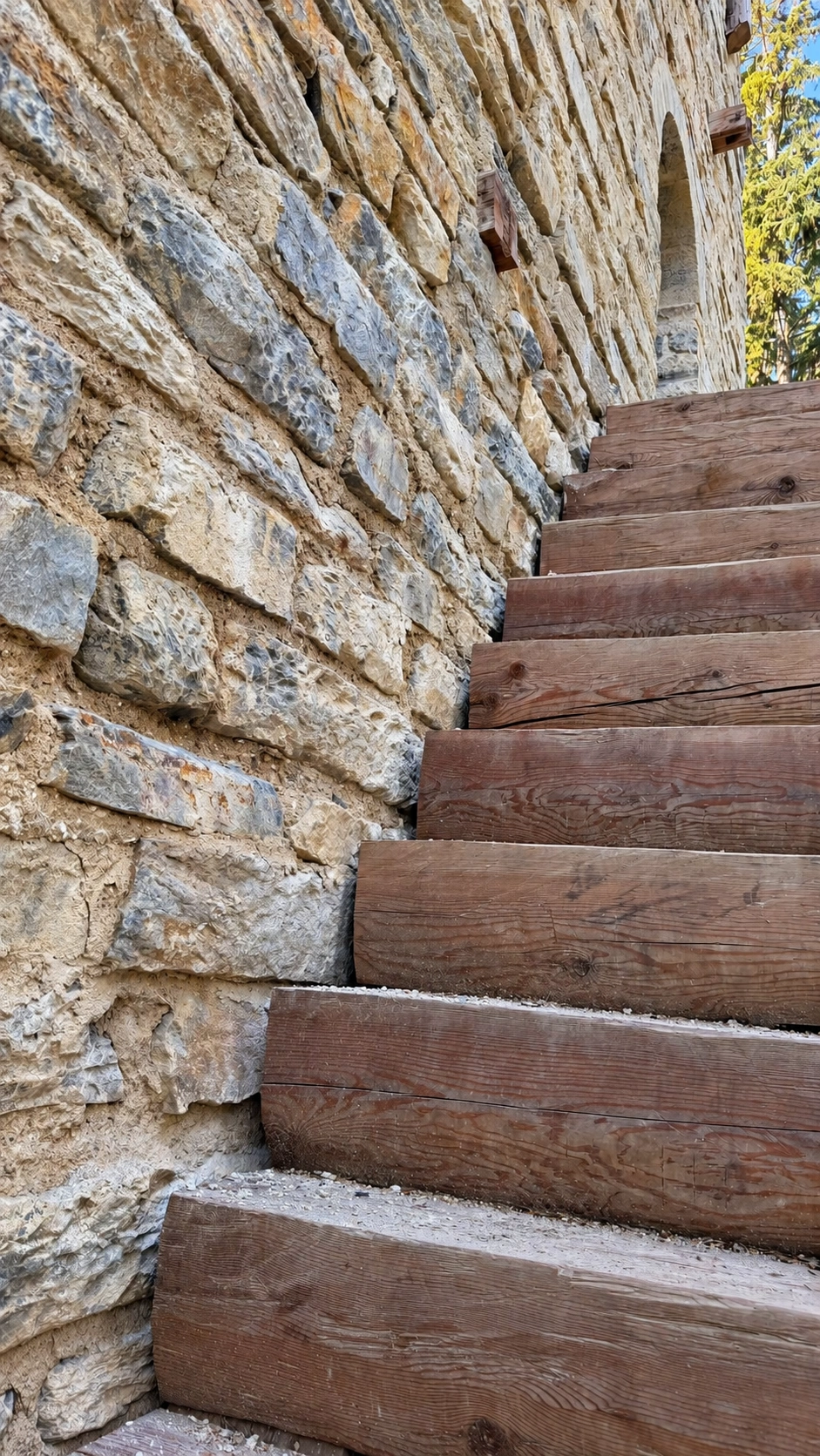Removable wooden staircase providing access to the raised entrance.